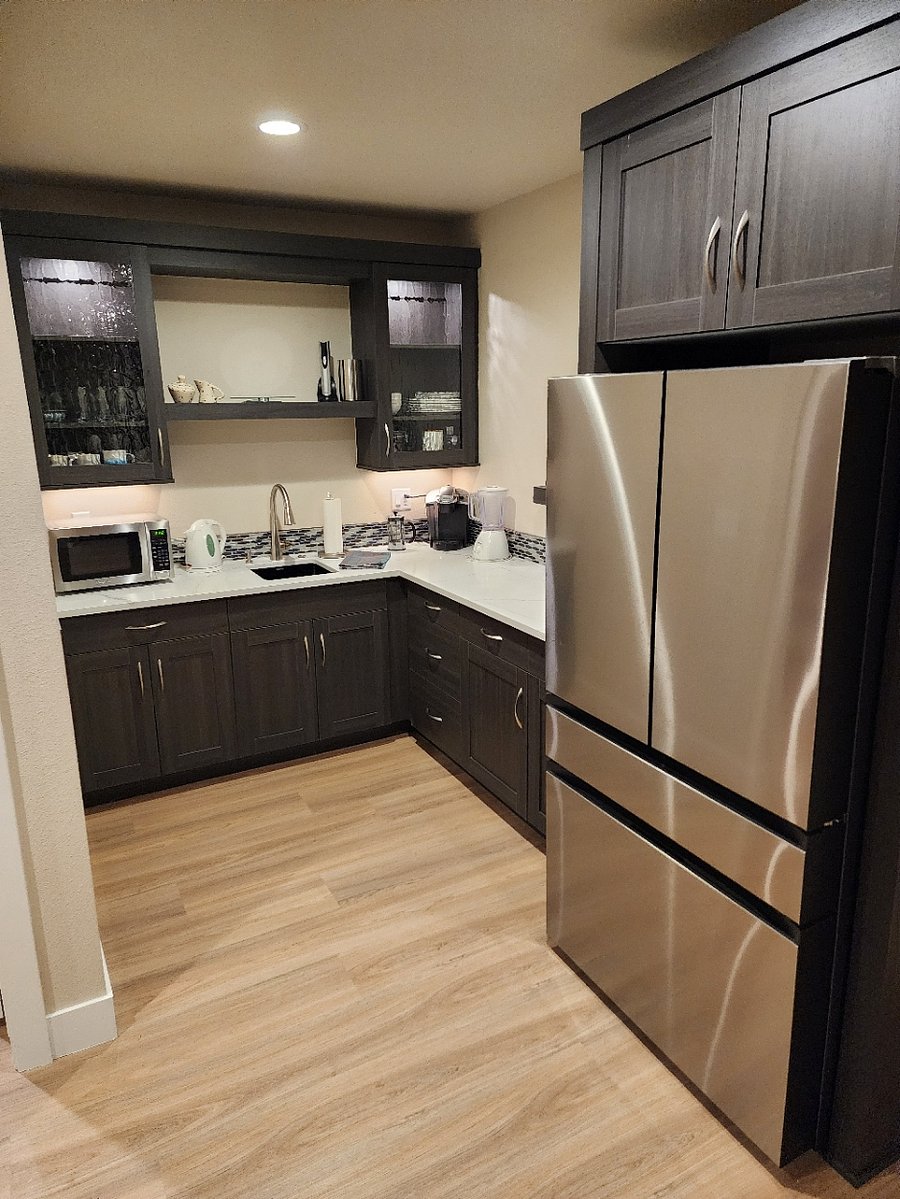 Nicely appointed kitchenette with ample storage and creative use of space. Custom tile and lighting.