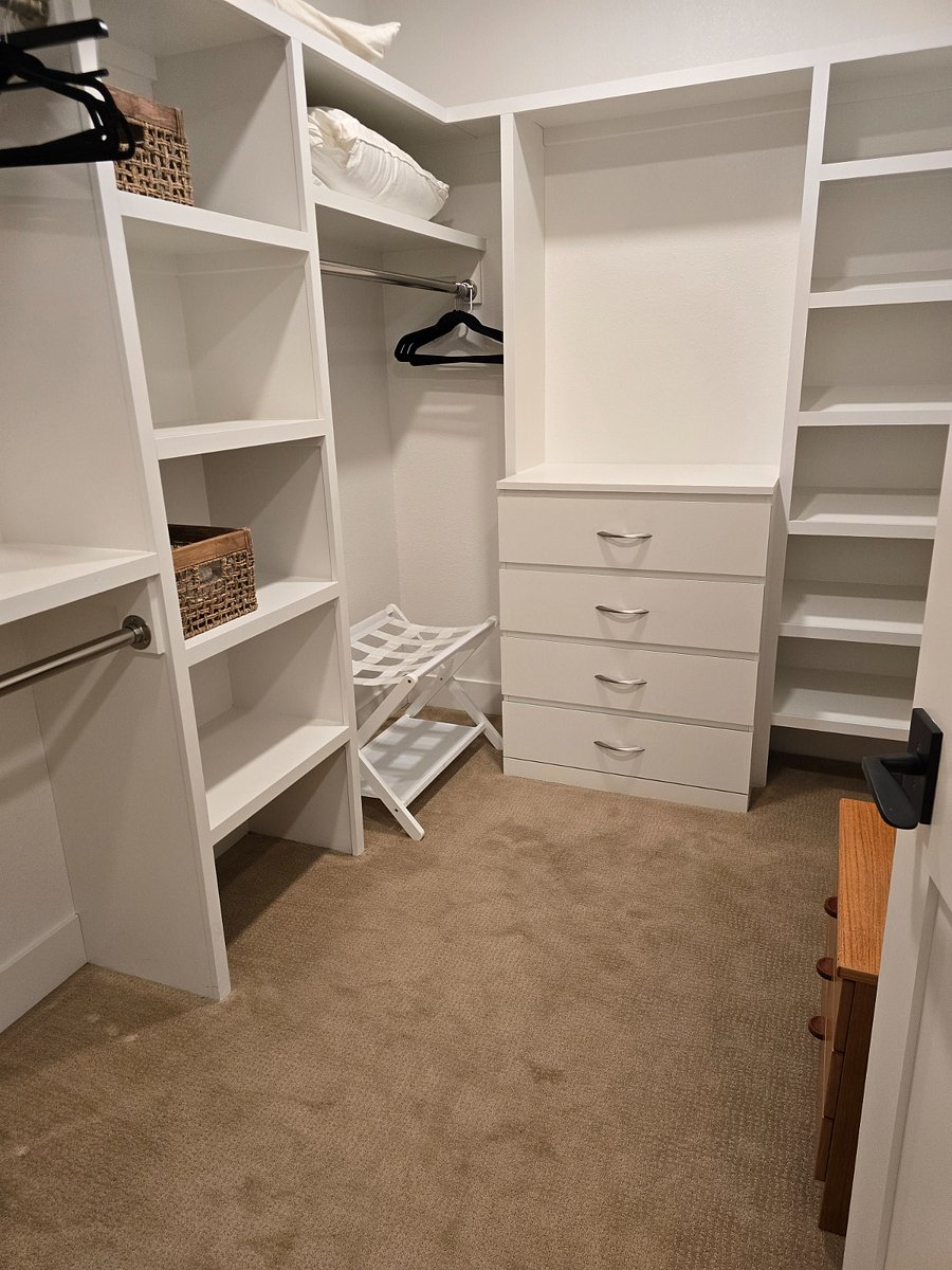 Spacious master closet with additional storage.