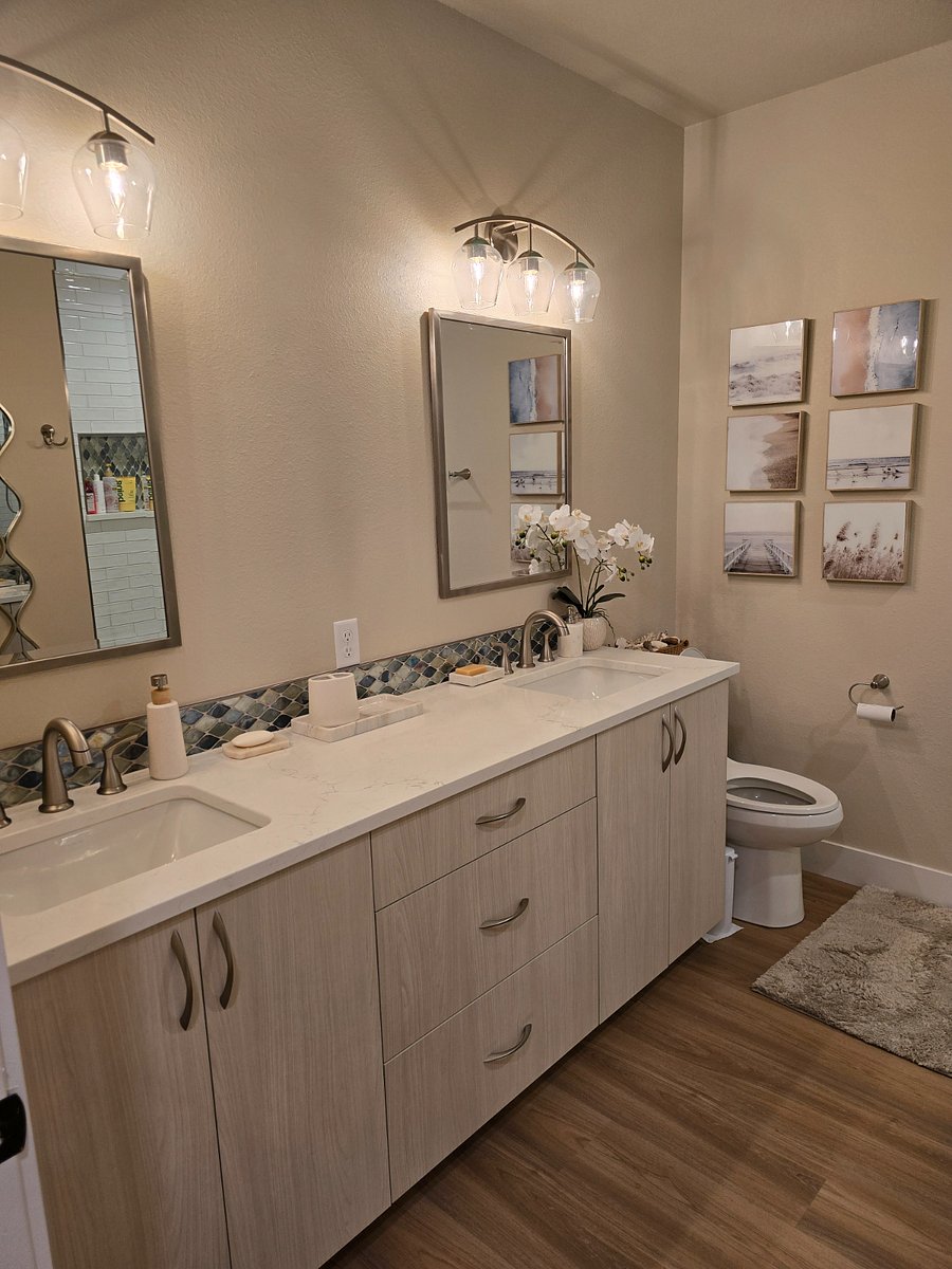 Double vanity in Master bathroom with custom tile and quartz countertops.  Generous additional storage.