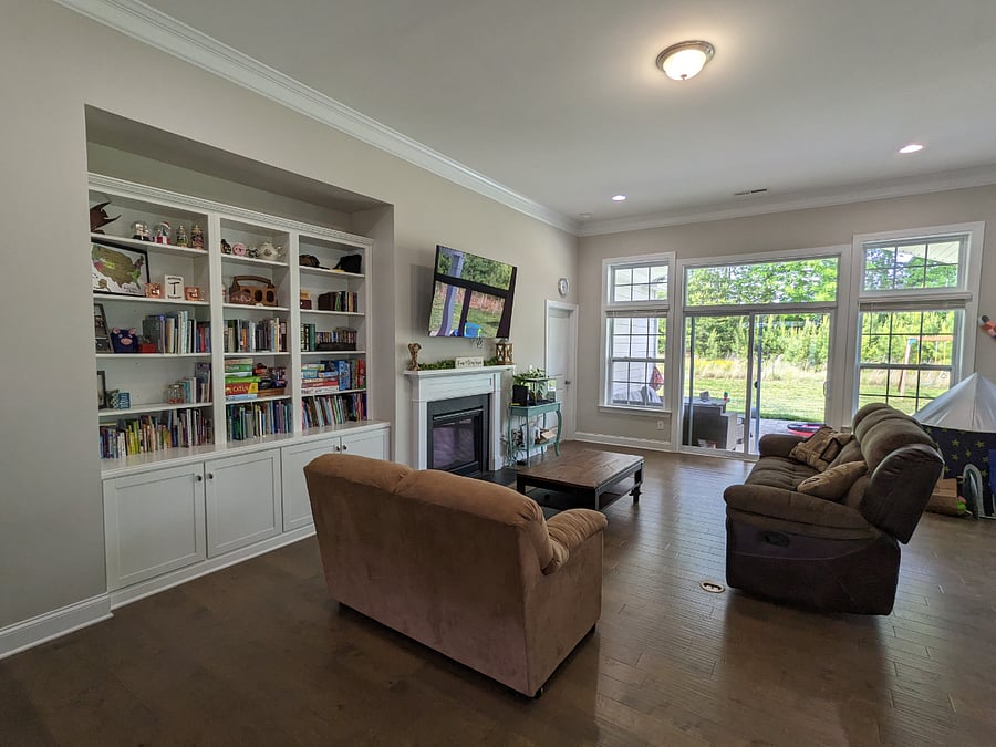 Main room with bookshelves, TV, and gas fireplace.