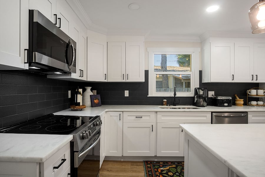 Kitchen has window above the sink and all granite countertops. 