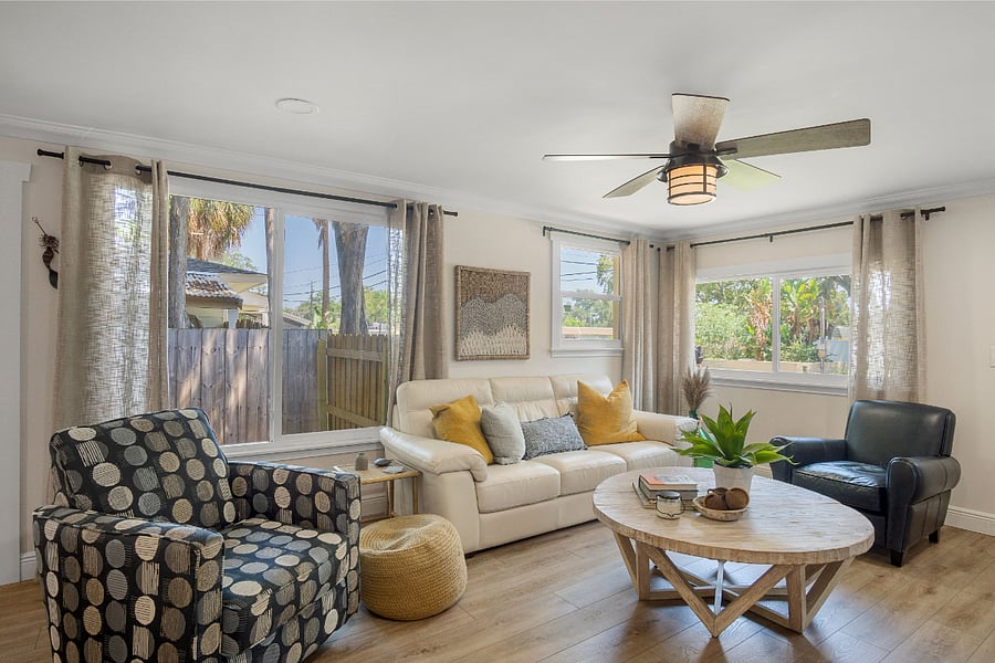 Ceiling fan and big windows allowing natural light to flood the home. 
Swivel corner chair. 