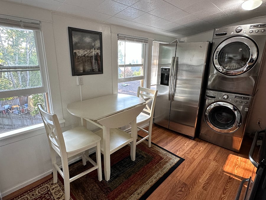 Full size refrigerator and stackable washer/dryer with territorial views from the windows.