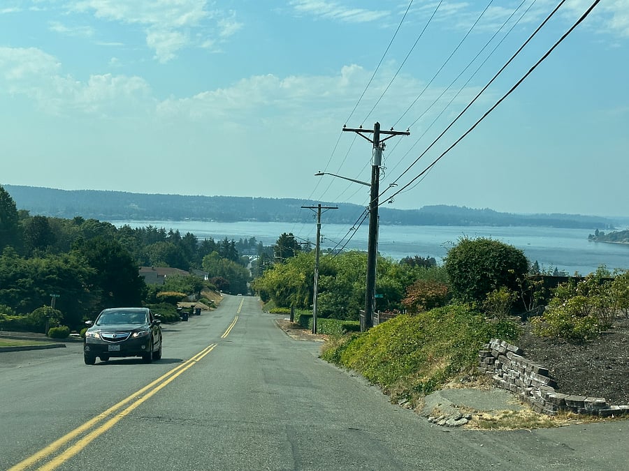 Sweeping views of Puget Sound and mountains beyond coming down the hill to the house.