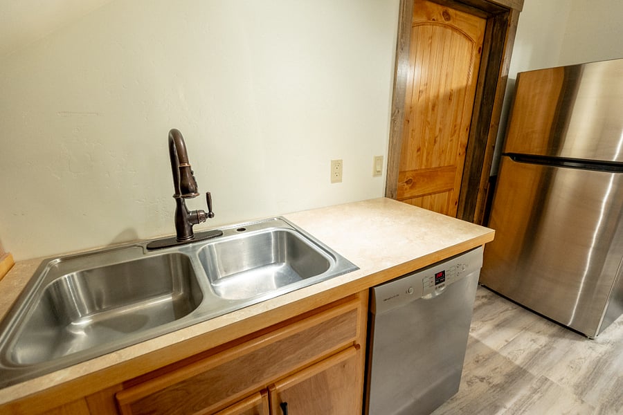 Double sink with dishwasher. Shelving to be installed above.
