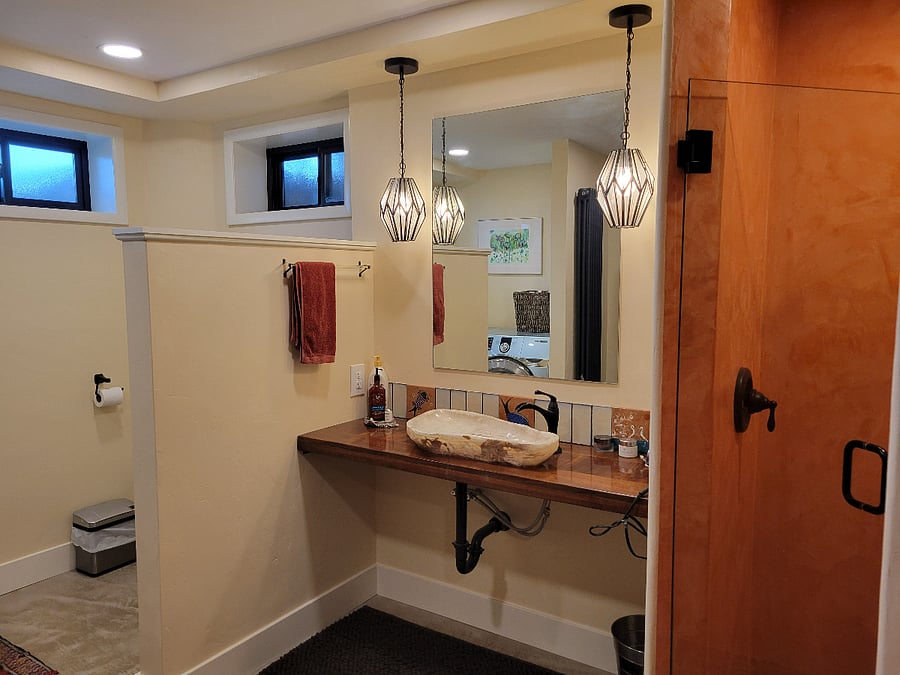 Huge bathroom with hand plastered walk in shower, and washer/dryer.