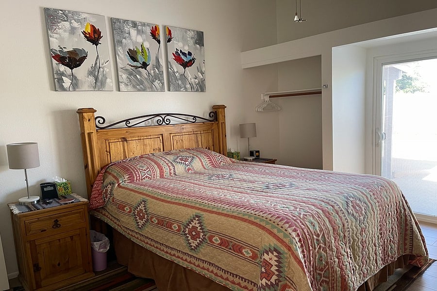 Primary Bedroom 1 with sliding doors to backyard and pool