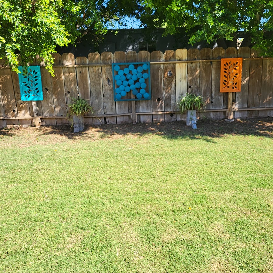 Fun back fence decorations. owner maintains all yards.