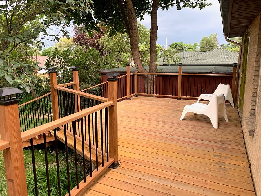 Back deck of house accessible via three french doors a rear of house facing east