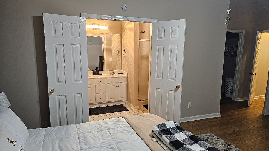 Double door entry into Master Bath with Jacuzzi tubm double sinks, stand in shower.