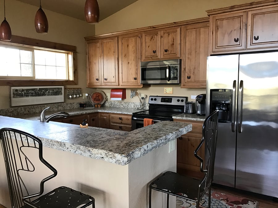 Full kitchen, including two door, stainless steel refrigerator with Icemaker, oven and stove with microwave over both, built-ins made from Alderwood with handmade handles and granite countertops. There is also a trash, compactor and dishwasher. 