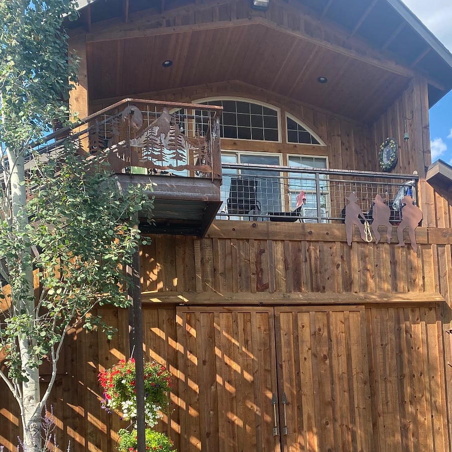 Front of the Miracle barn, showing the large windows in the living room and sliding glass door off of the deck
