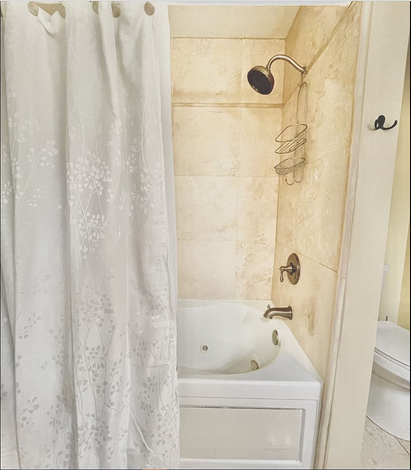 Tile shower and bathtub in guest bathroom