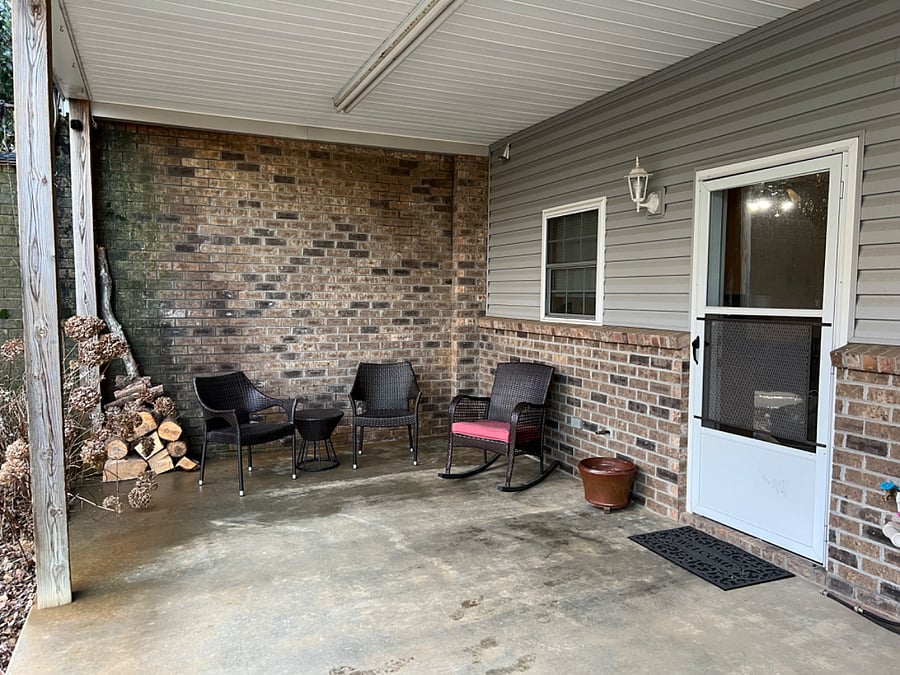 Apartment entry with outdoor sitting area to enjoy the fresh air.