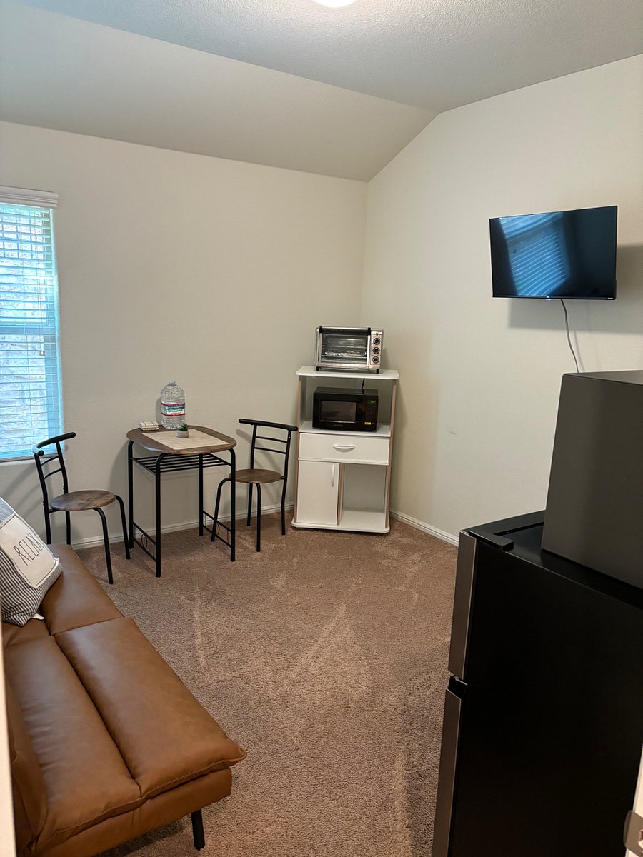 Living Dining area with fridge, microwave, oven
Smart TV, dinning table and Sofa