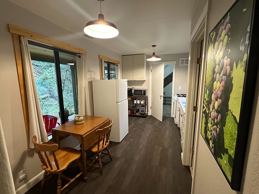 Kitchenette with door leading to foyer.