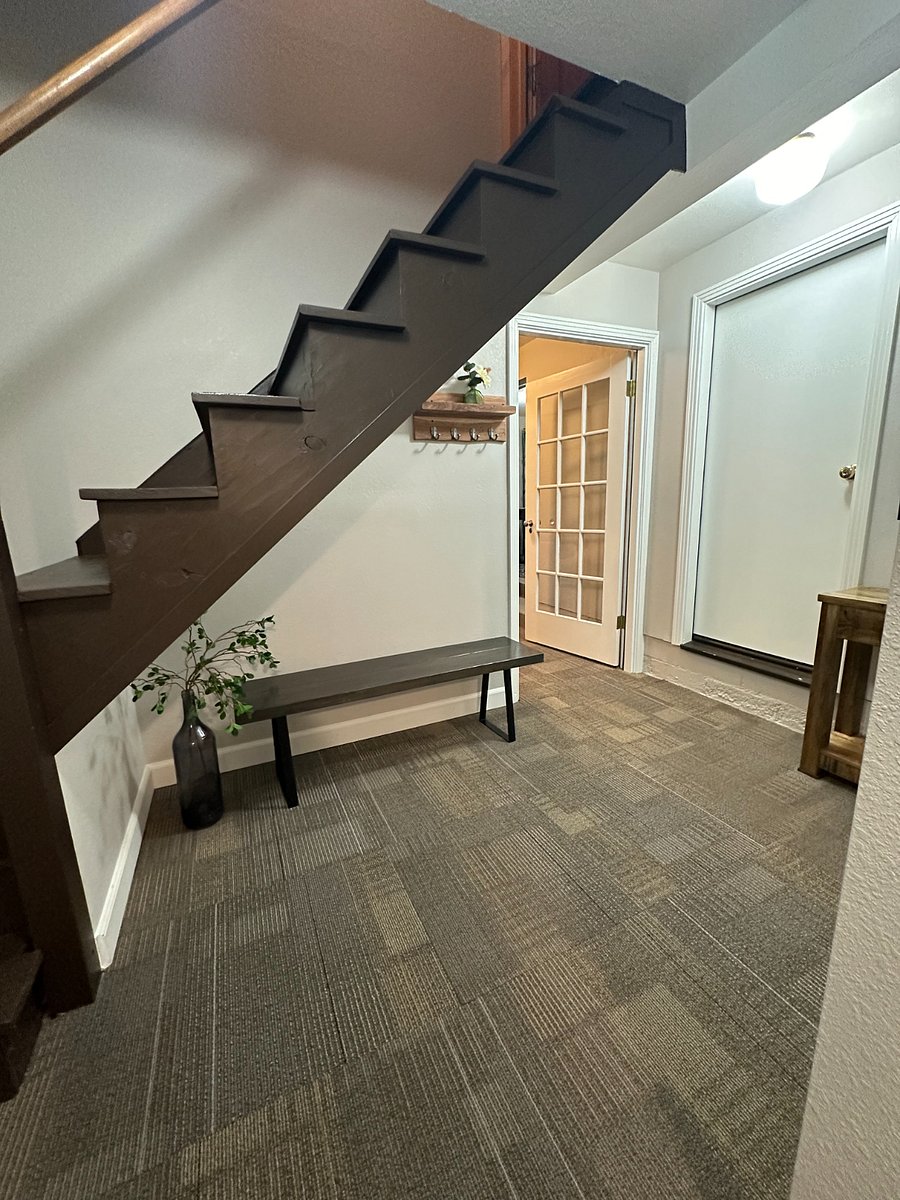 Foyer with door leading to the living room. (Stairwell leads to owners' unit not available to tenant).