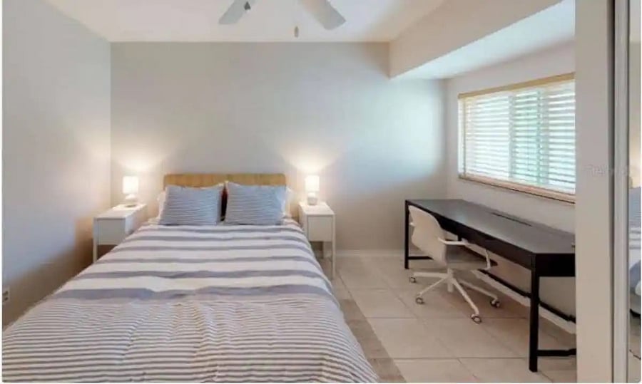 queen size bed and work area in the guest bedroom
