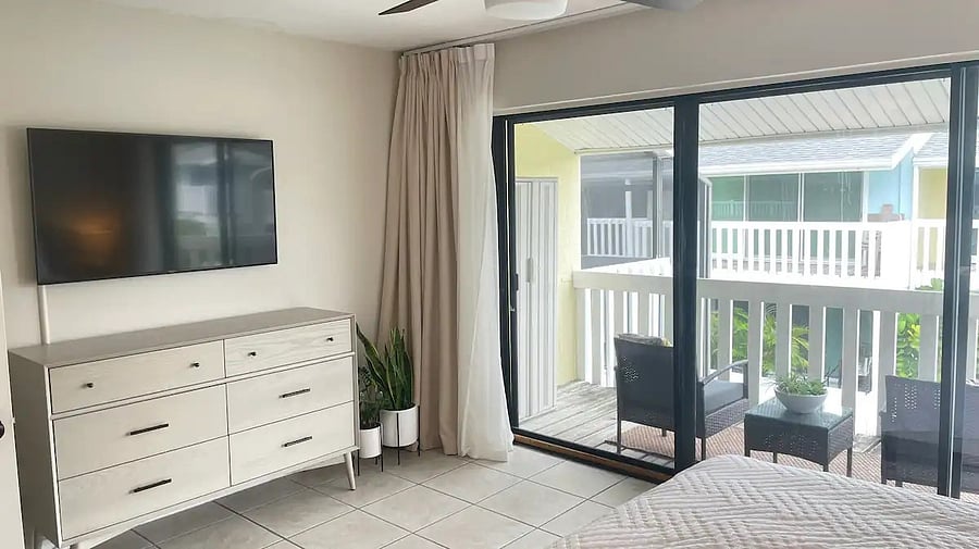 the primary suite has an upper balcony over looking the pool