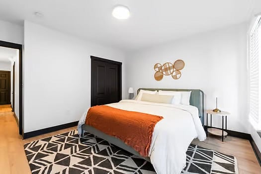 Bedroom 1 includes a welcoming king size bed, dresser, smart TV, closet, and plenty of space.
