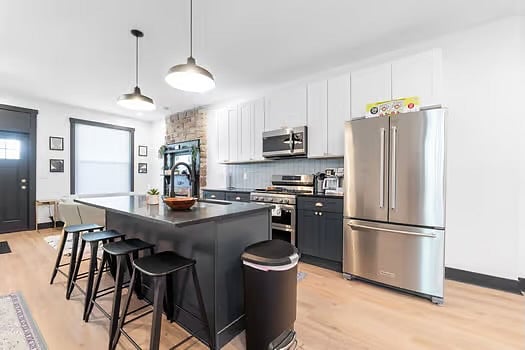 Fully equipped kitchen with new appliances, granite countertops, and slow close cabinets.