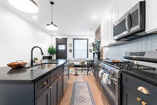Fully equipped kitchen with new appliances, granite countertops, and slow close cabinets.
