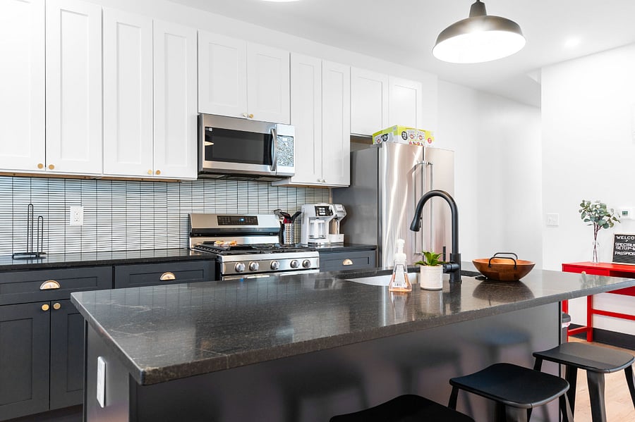 Fully equipped kitchen with new appliances, granite countertops, and slow close cabinets.