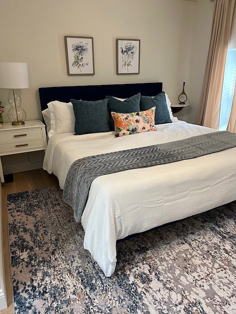 Fourth bedroom on the third floor with King bed, plush blanket, luggage racks and full size mirror.  