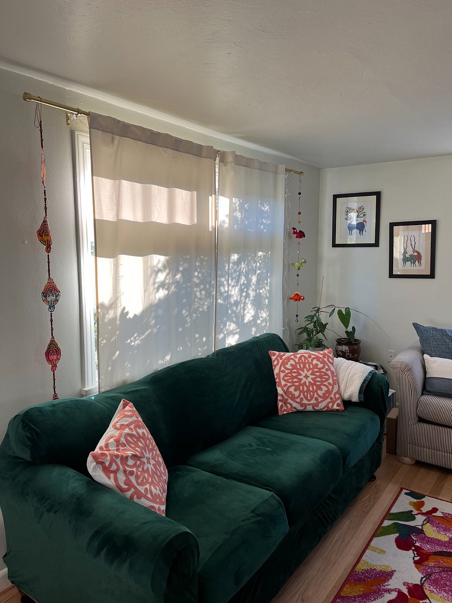 living room with Smart TV at end and 2 windows
