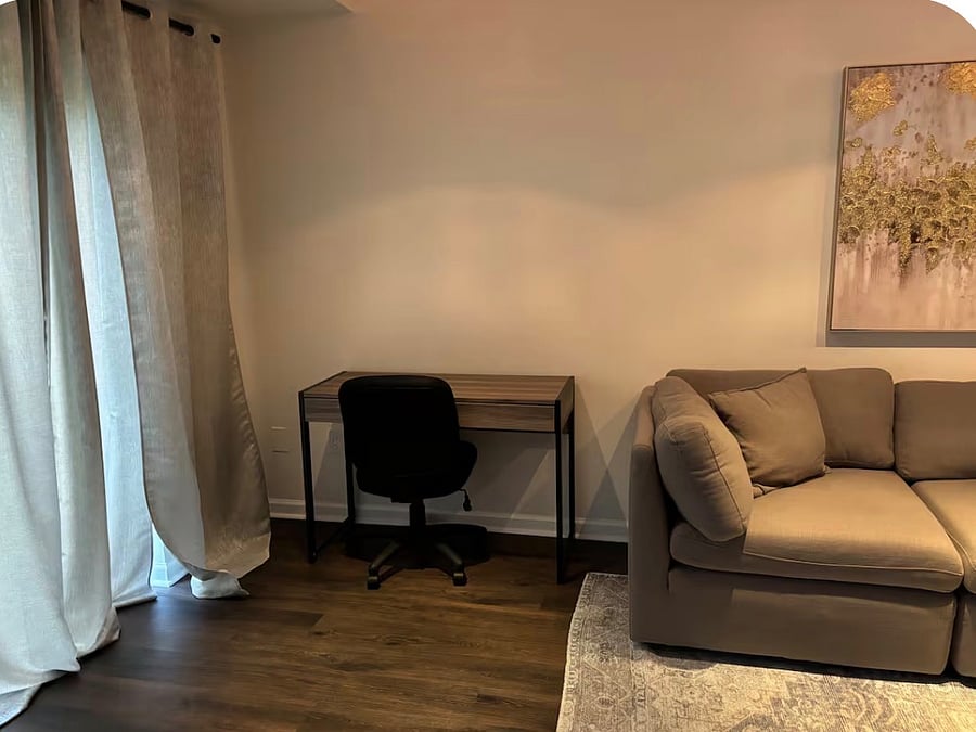 one of two desks, desk in living room, near balcony