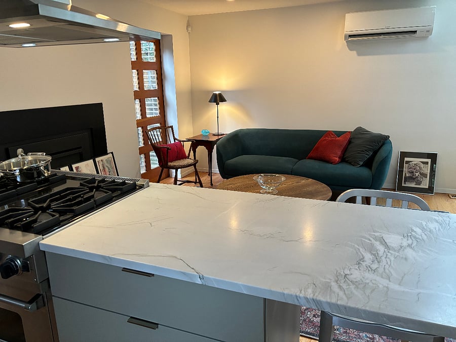 'Cook's view' into east side seating area. Fully remodeled kitchen. Viking gas stove, custom cabinets, quartz counters, new fixtures. Gas fireplace in seating area for cozy winters.