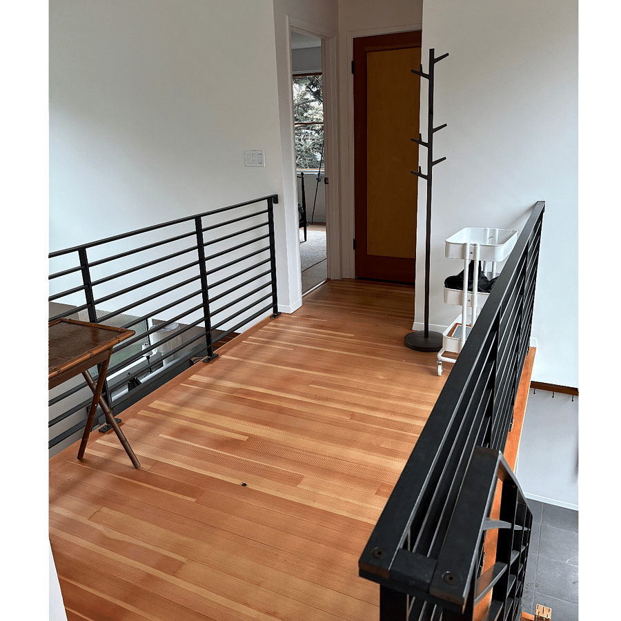 Second floor bridge hallway between bedrooms and toward full bath and linen closet. No shared BR walls.