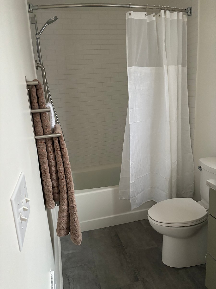 Full bathroom with tub and shower. Hand bar installed on left for steady step over. Fully remodeled.