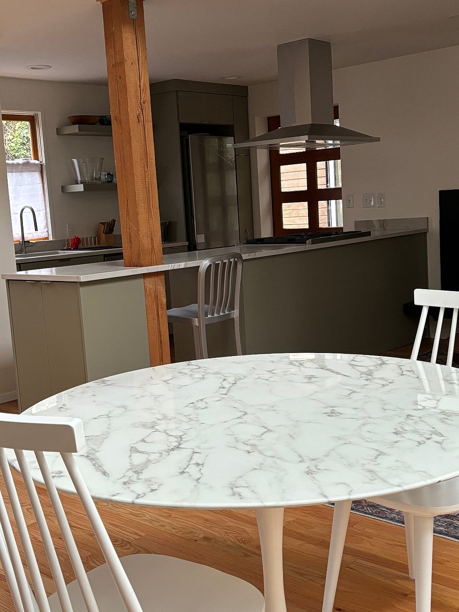 View from stone dining table into kitchen area.
