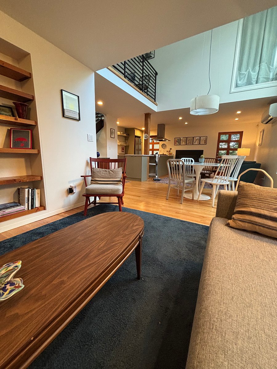 Seating near TV, bookcase - view into dining & rest of first floor.