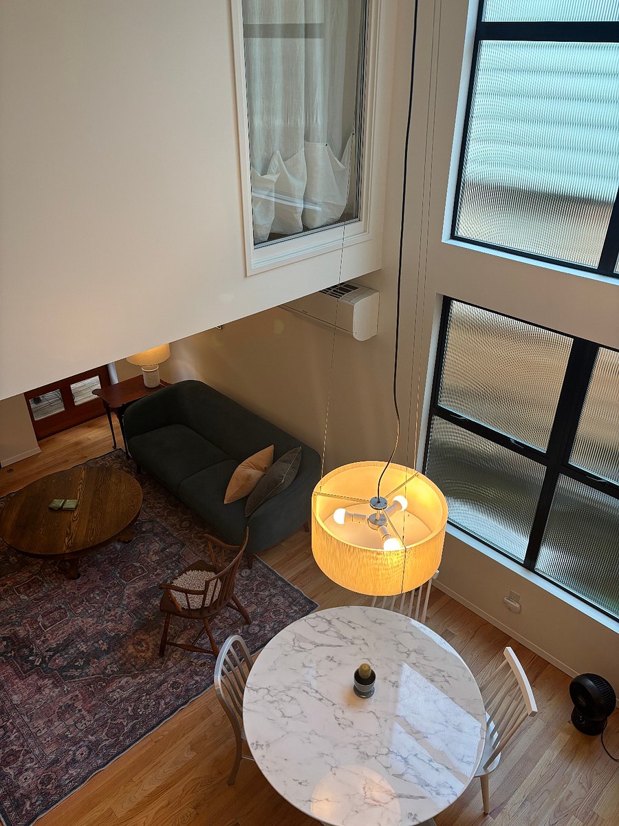 View from upstairs loft hallway into first floor.