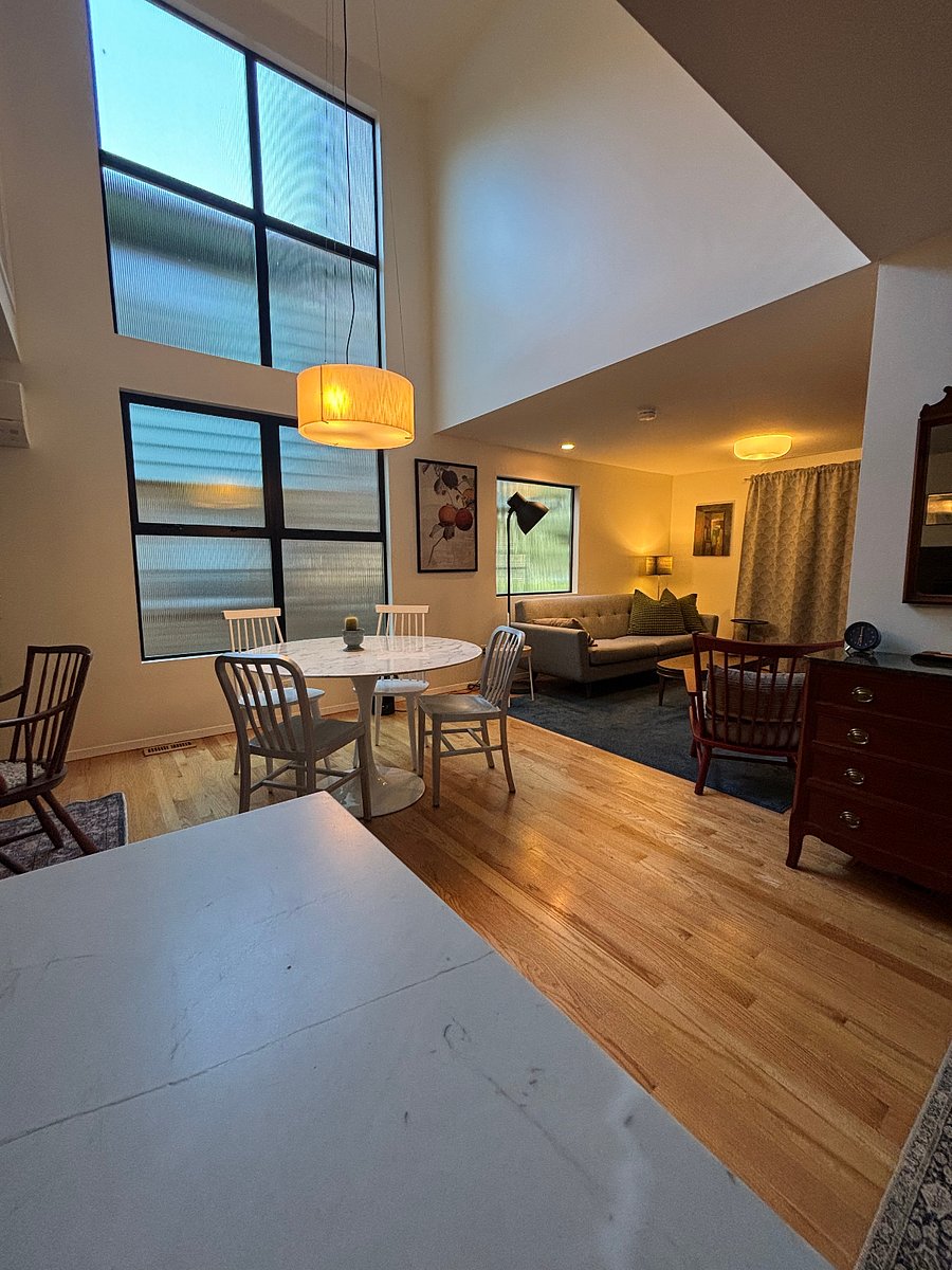 View from kitchen into open dining area & seating near TV.