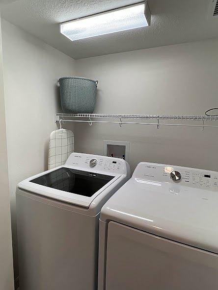 Washer (laundry detergent included upon arrival) and dryer, iron and table-top ironing board.