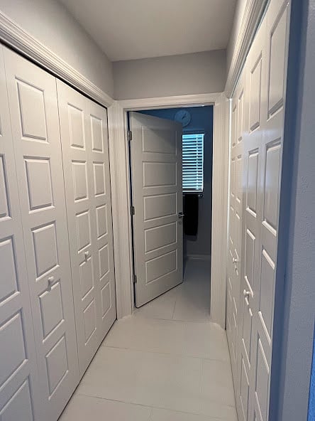 Hallway off main entry way that leads to second full bathroom. On the right is the washer and dryer, to the left is the furnace.