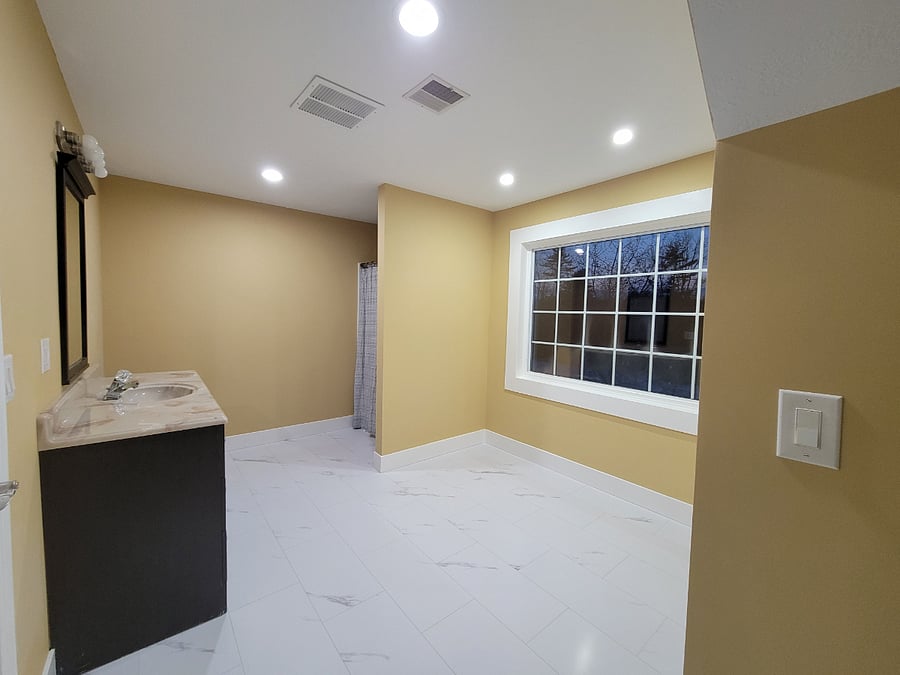 Bathroom has view of backyard which abuts the woods