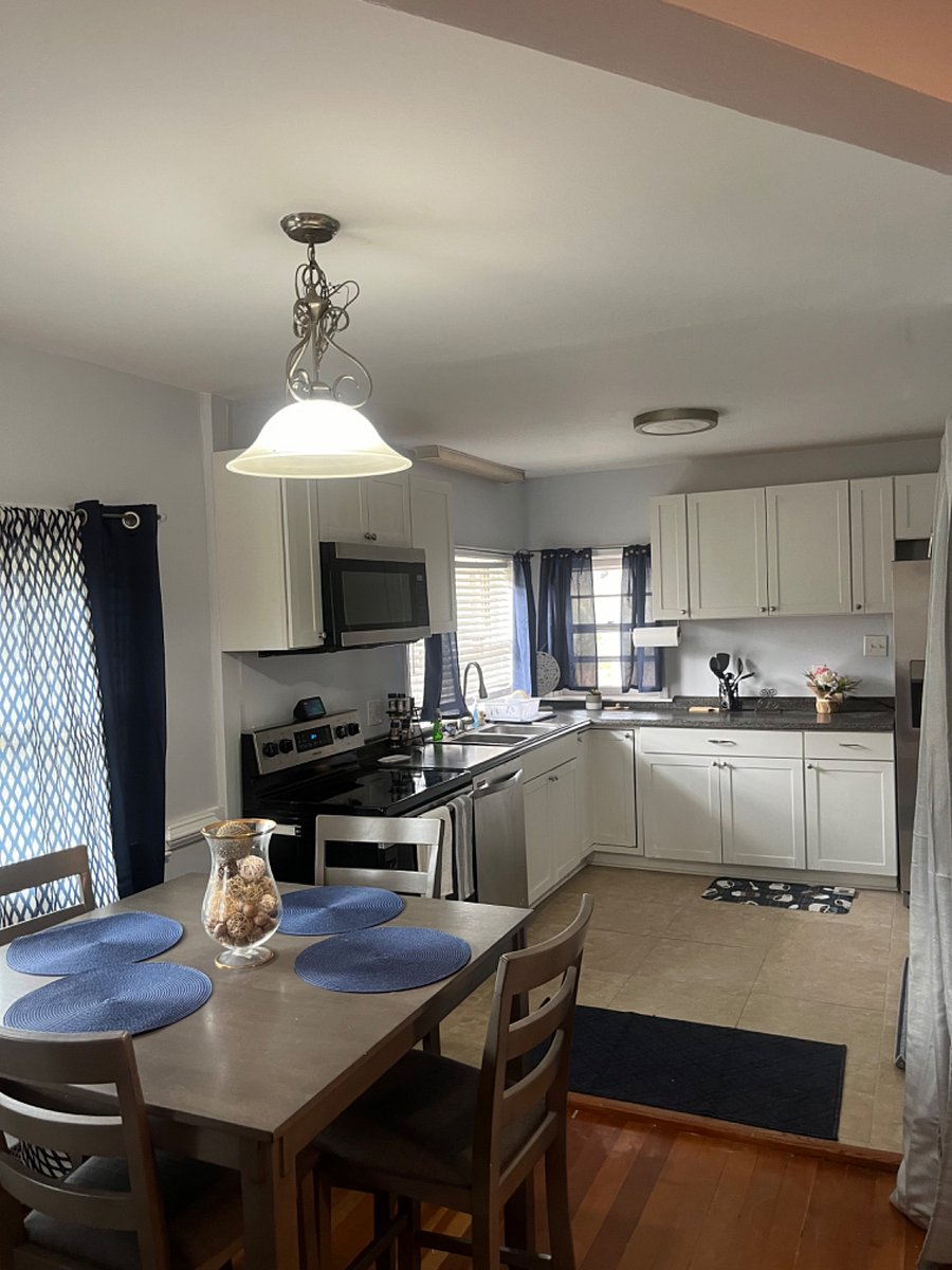 Upgraded modern kitchen stocked with pans, utensils, dishes and other necessities to make you at home.