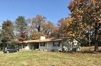 Corner lot with house set back from the street.