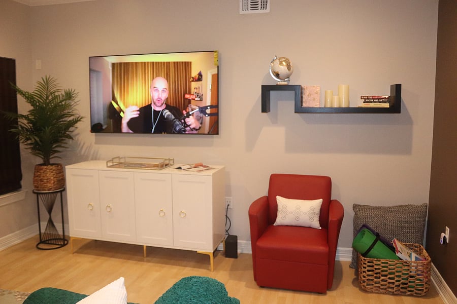Functional living area has smart TV.  Wellness corner has exercise mats, resistance bands, and color therapy book.