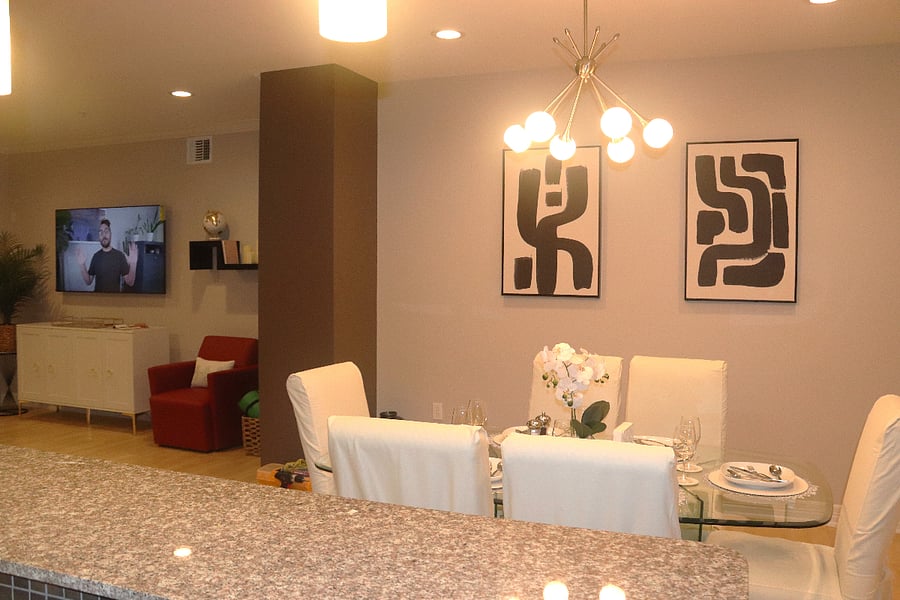 Dining room flows into living area with bar seating for 2 additional guests.