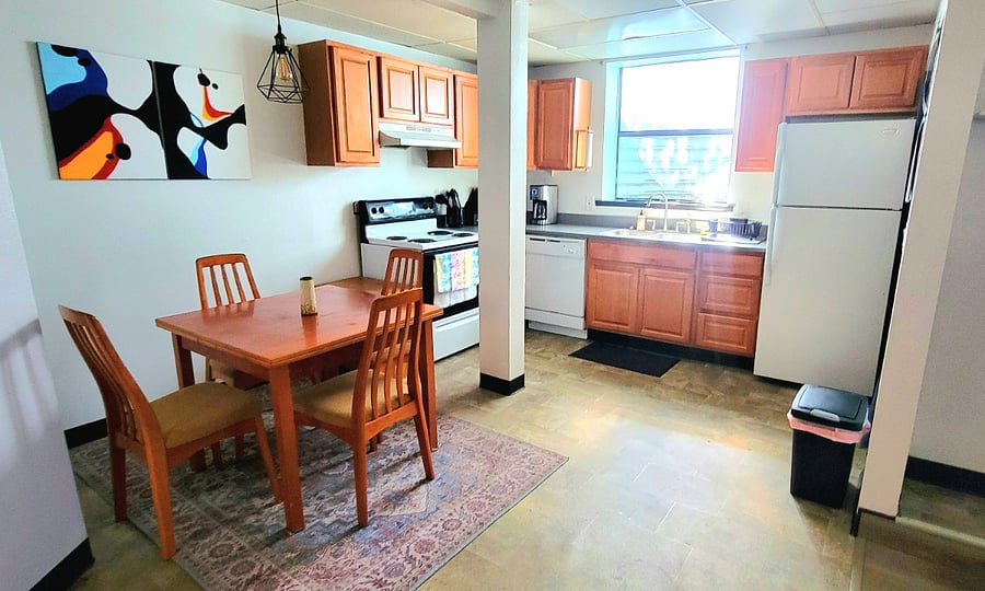 Kitchen, dining, open concept to living room. Washer and dryer is off kitchen near refrigerator