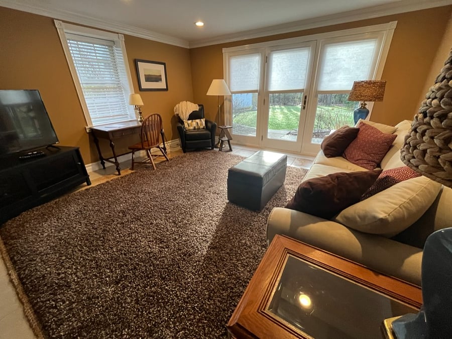 Private Living Room with Private Entrance. Desk, Sofa, Recliner, Arm Chair, Tables, and Large Screen TV