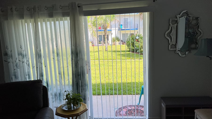 Straight-on view from living area; entrance to pool lined with flowers
