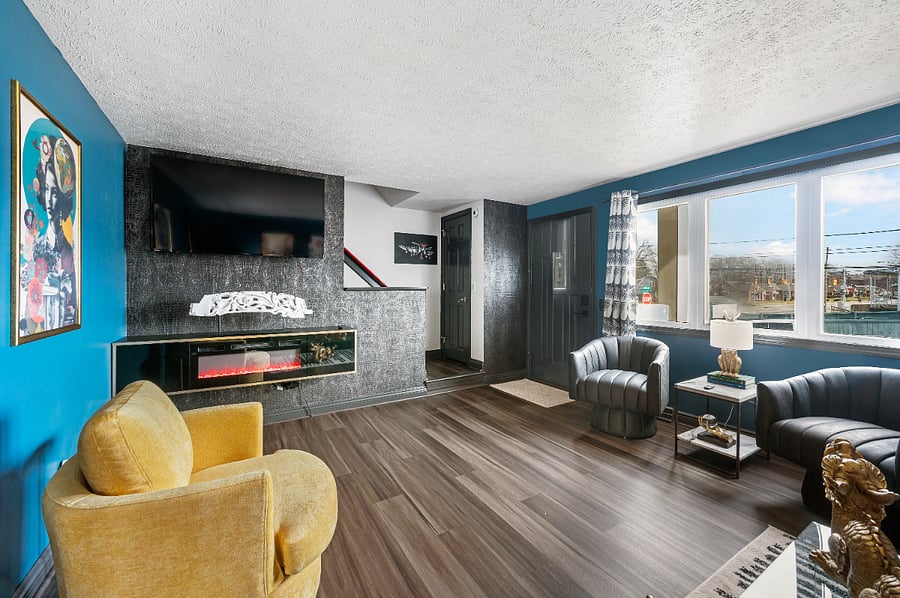 Floating fireplace with remote.  Smart TV with Netflix, against the stunning alligator wallpaper accent wall. 
