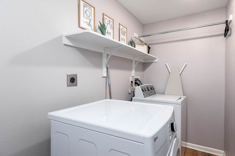 Laundry room: Washer and Dryer, iron and hangers.