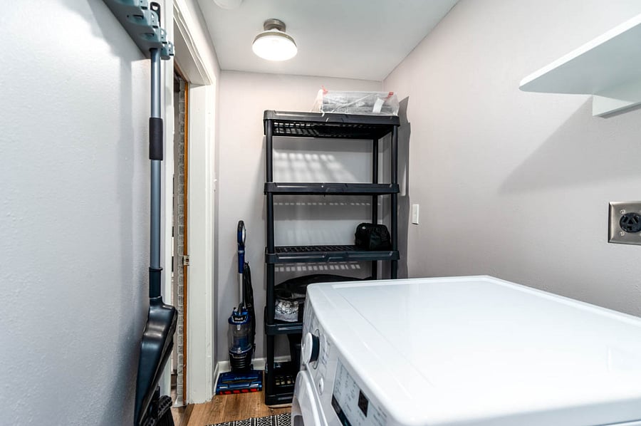 Laundry room: Storage shelve, vacuum cleaner, extra towels and lines.